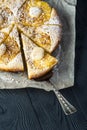 Cutted pineapple pie on baking paper with scapula