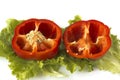 Cutted sweet red pepper on salad leaves Royalty Free Stock Photo