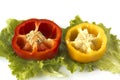 Cutted sweet yellow and red peppers on salad leaves Royalty Free Stock Photo