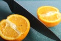 Two halves orange fruit on green board Royalty Free Stock Photo