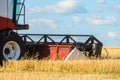 Cutter platform of reaping machine at work. Combine harvester in the field