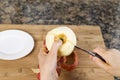 Cutting Apple in Half with Paring Knife Royalty Free Stock Photo