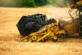 Cutting bar unit or reaper machine cuts stems. Combine harvester working in wheat field. Harvesting machine driver Royalty Free Stock Photo