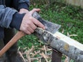 Cutting bark from a log with an ax Royalty Free Stock Photo