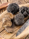 Cutting of black truffle on the wooden board