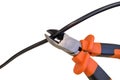 Cutting black wire by nippers, trimming the cable, on white background Royalty Free Stock Photo
