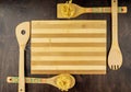 Cutting Board and appliances made of bamboo with paste on a dark chocolate wooden background