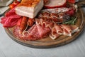 Cutting board with different meat delicacies on table Royalty Free Stock Photo