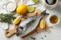 Cutting board with Dorado fish and cooking ingredients on background, top view Royalty Free Stock Photo