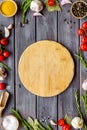 Cutting board in frame of food for chef work on wooden background top view space for text Royalty Free Stock Photo