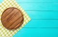 Cutting board and green plaid tablecloth on blue wooden background. Top view and copy space. Place for text Royalty Free Stock Photo