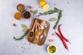 Cutting board with herbs and spices - rosemary, garlic, salt, pepper, olive oil, lemon. Culinary background. Royalty Free Stock Photo