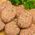 On cutting board homemade uncooked meatballs, kofte