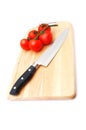 Cutting board with a knife and tomato Royalty Free Stock Photo