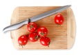 Cutting board with a knife and tomato on white background Royalty Free Stock Photo