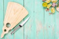 Cutting board with a knife on a vintage wooden table. Handmade chopping board with lime pieces and spices. Top view, place for Royalty Free Stock Photo