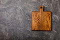 Cutting board over towel on wooden kitchen table. Royalty Free Stock Photo