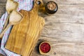 Cutting board over towel on wooden kitchen table. Royalty Free Stock Photo