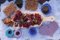 A cutting board with Traditional tapas with spanish cured meat, bread chips with seed, sun dried tomato , parsley, wooden