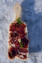 A cutting board  with  Traditional  tapas    with  spanish cured meat, sun dried tomato,  parsley on background Royalty Free Stock Photo