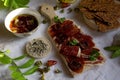 A cutting board  with  Traditional  tapas    with  spanish cured meat, sun dried tomato , parsley and bread chips with seed,  dry Royalty Free Stock Photo