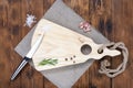 Cutting board on a wooden table with spices and a knife. Handmade chopping board. View from above Royalty Free Stock Photo