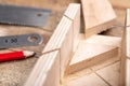 Cutting boards with a handsaw at an angle in the template. Minor carpentry work in the workshop. Royalty Free Stock Photo