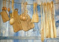 Cutting boards and wooden spoons hanging on the wall, tableware Royalty Free Stock Photo