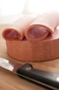 Cutting bologna sausage with knife Royalty Free Stock Photo