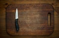 Cutting breadboard and knife overwooden background