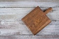 Cutting brown board on old shabby wooden background. Background with copy space, overhead, top view Royalty Free Stock Photo