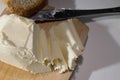 Cutting butter spread in sunlight shot close up
