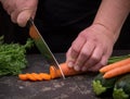 Cutting carrot on a stone table for meal preparation Royalty Free Stock Photo