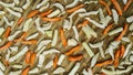 Cutting carrots, squash and radish into small pieces for drying