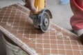 Cutting ceramic tiles. A worker places a large tile in a machine Royalty Free Stock Photo