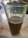 Cutting chai glass of hot tea kept on restraunt table in Bandra Mumbai in foreground