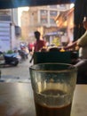 Cutting chai glass of hot tea kept on restraunt table in Bandra Mumbai in foreground