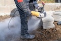 cutting concrete bricks with an electric grinder Royalty Free Stock Photo