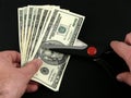 Cutting Costs - Scissors and US Dollars Royalty Free Stock Photo