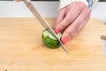 Cutting cucumber into small pieces to make salad. Royalty Free Stock Photo