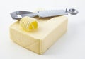 Cutting a curl off a pat of fresh butter