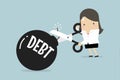 Cutting debt bomb, businesswoman`s hand holding scissors to cut debt.