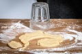 Cutting Dough Circles With an Upside-Down Glass on a Floured Wooden Surface Royalty Free Stock Photo