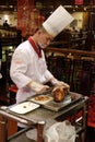 Cutting duck on a plate in the original Quanjude restaurant in Beijing