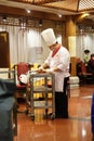 Cutting duck on a plate in the original Quanjude restaurant in Beijing