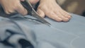 Cutting the fabric with sharp scissors. Cut the fabric with tailor`s scissors Royalty Free Stock Photo