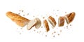 Cutting fresh baked loaf wheat baguette bread with crumbs and seeds flying isolated on white