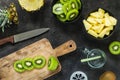 Cutting fresh kiwi and pineapple. Smoothie ingredients. Top view Royalty Free Stock Photo