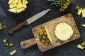 Cutting fresh pineapple and pineapple on wooden board. Top view Royalty Free Stock Photo