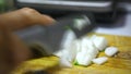 Cutting of garden radish for salad on wooden